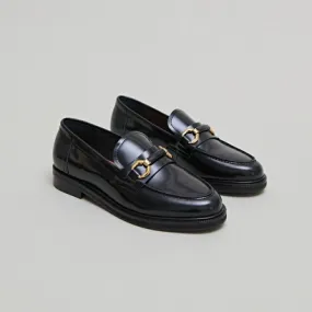 Loafers with gold bits in black glazed leather