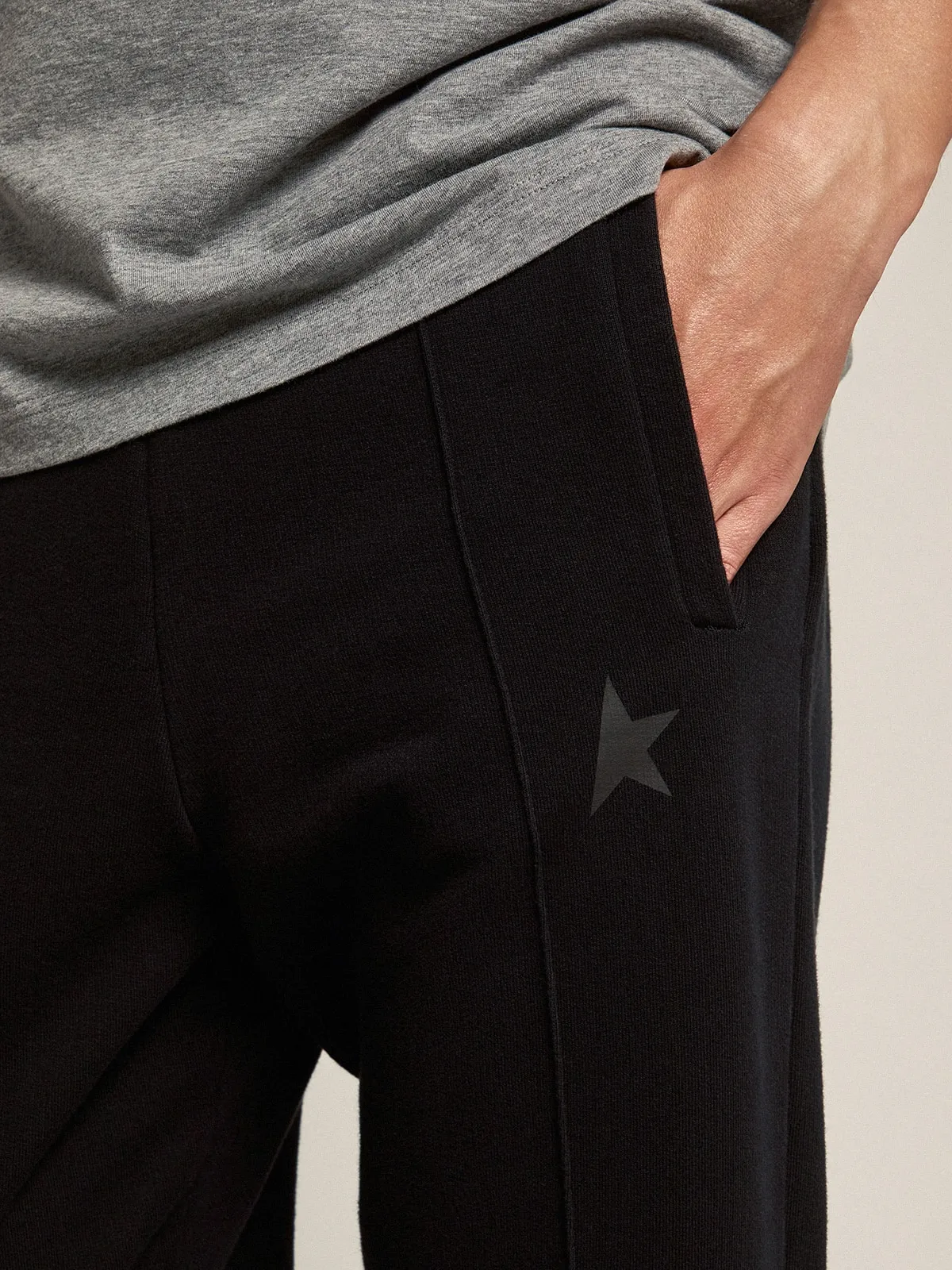 Men's black joggers with star on the front