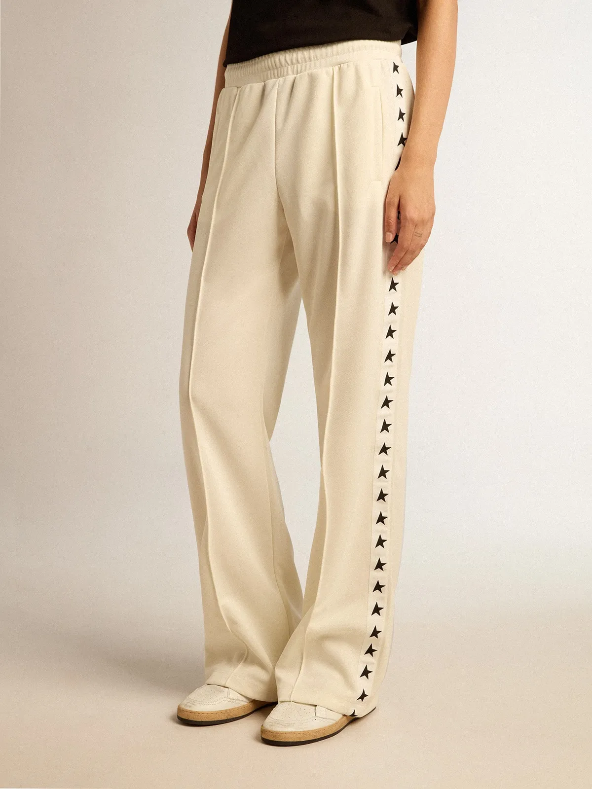 Women’s white joggers with stars on the sides