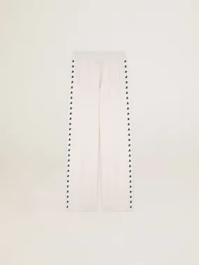 Women’s white joggers with stars on the sides